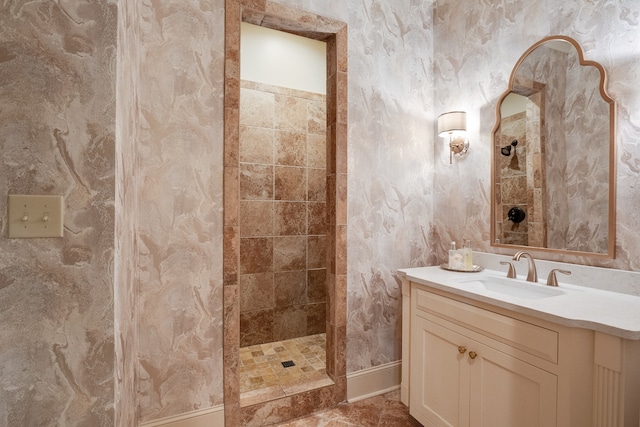 bathroom featuring tile floors, vanity, and tiled shower