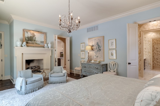 bedroom with an inviting chandelier, ornamental molding, and dark wood-type flooring