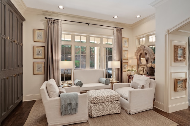 living area featuring dark wood-type flooring and crown molding