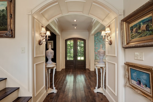 entrance foyer with french doors, dark wood-type flooring, and ornamental molding