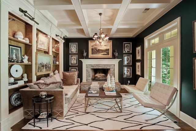 sitting room with coffered ceiling, beamed ceiling, dark hardwood / wood-style floors, a notable chandelier, and a fireplace