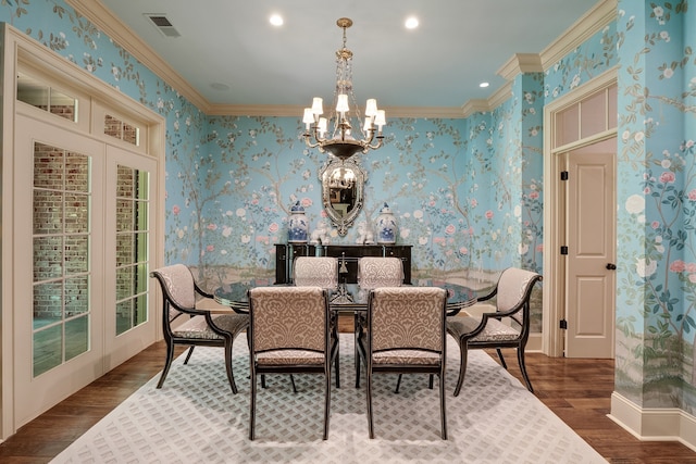 dining room with a notable chandelier, dark hardwood / wood-style floors, and ornamental molding