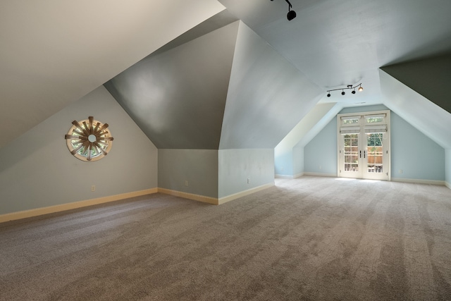 bonus room with french doors, lofted ceiling, and light colored carpet