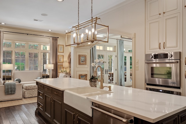 kitchen featuring french doors, light stone counters, hanging light fixtures, a chandelier, and stainless steel dishwasher