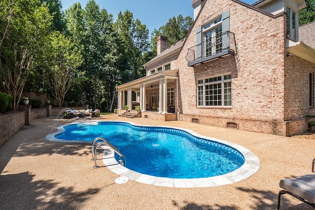 view of swimming pool featuring a patio area