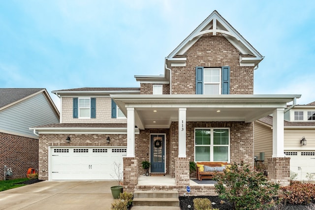 craftsman-style home featuring covered porch and a garage