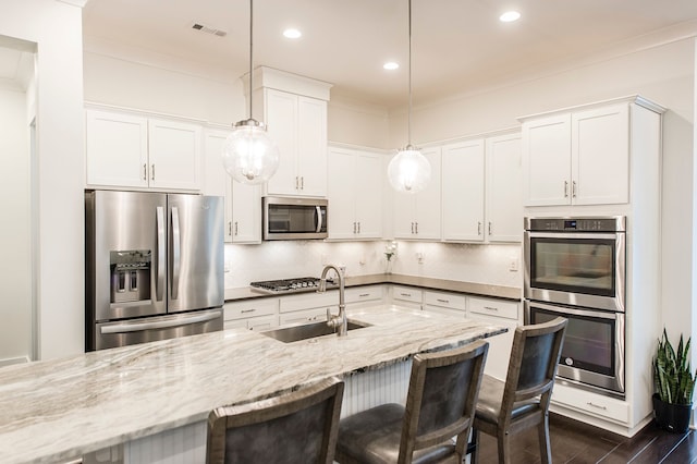 kitchen featuring white cabinets, tasteful backsplash, and stainless steel appliances