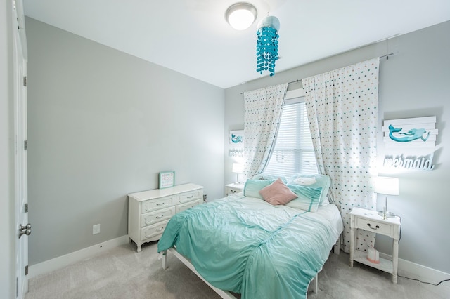 bedroom featuring light carpet