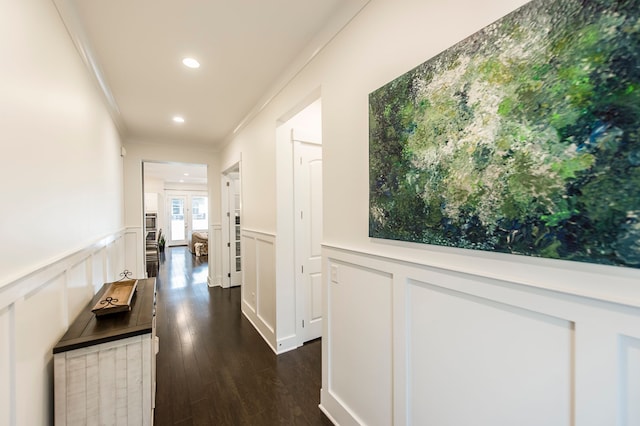 corridor with dark hardwood / wood-style flooring and crown molding