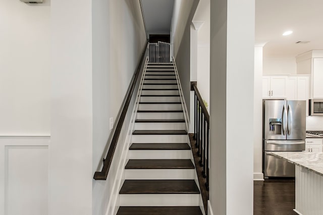 stairs with dark hardwood / wood-style flooring