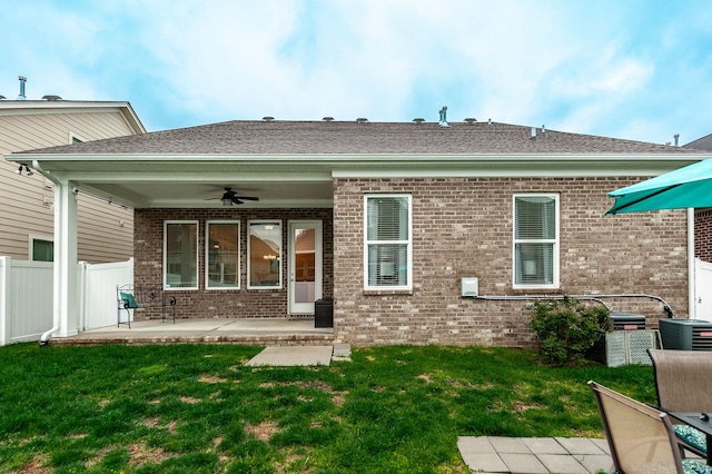 rear view of property with a lawn, central AC, a patio area, and ceiling fan