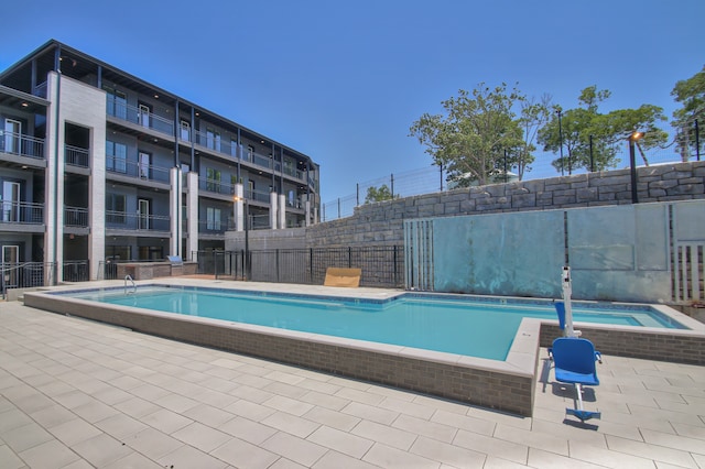 view of swimming pool featuring a patio