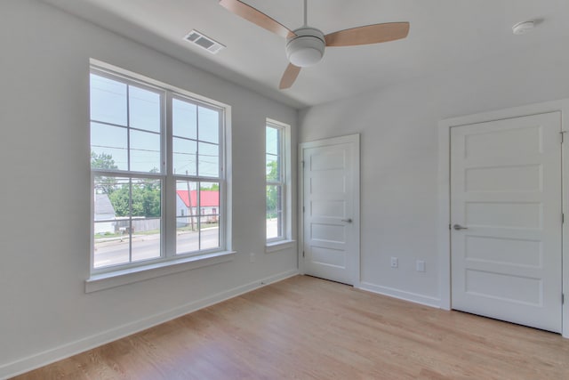 spare room featuring light hardwood / wood-style floors and ceiling fan