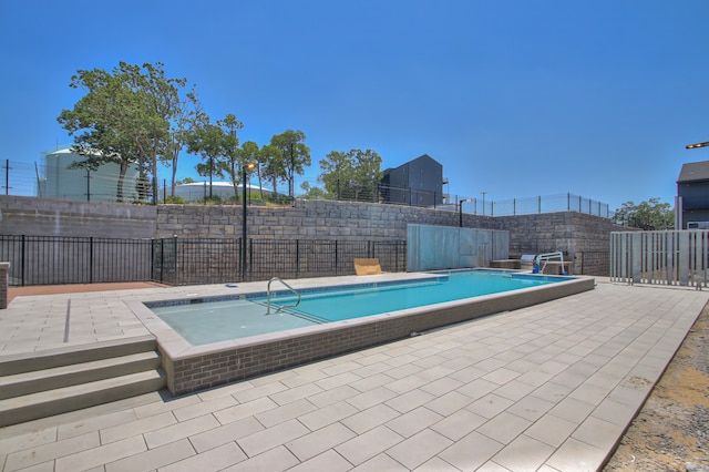 view of swimming pool featuring a patio area