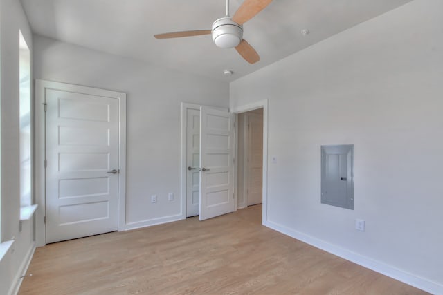 empty room with ceiling fan and light hardwood / wood-style flooring