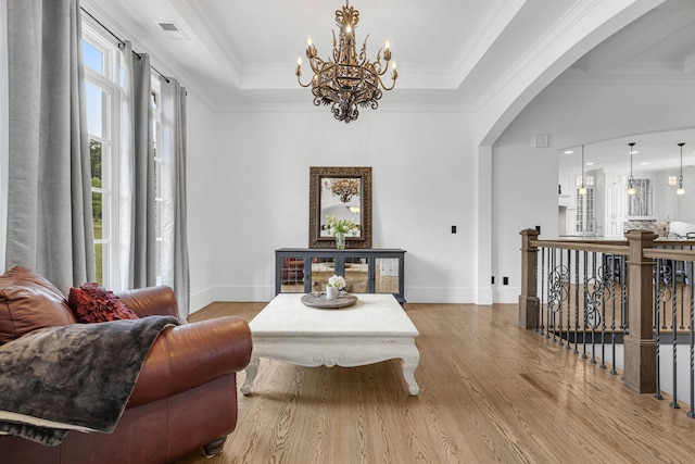 3609 Leipers Valley Trl, Franklin, TN 37064 - living room with a chandelier, a tray ceiling, light hardwood / wood-style floors, and crown molding
