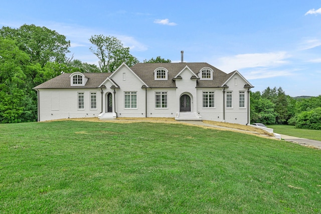 french provincial home featuring a front yard