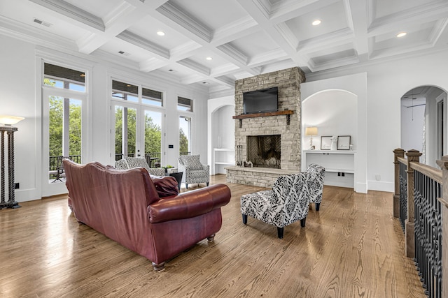 3609 Leipers Valley Trl, Franklin, TN 37064 - living room featuring beam ceiling, light hardwood / wood-style floors, coffered ceiling, and a stone fireplace