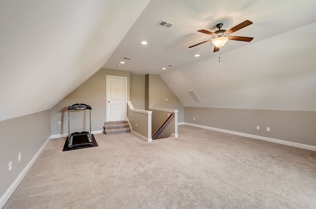 additional living space with ceiling fan, lofted ceiling, and light carpet