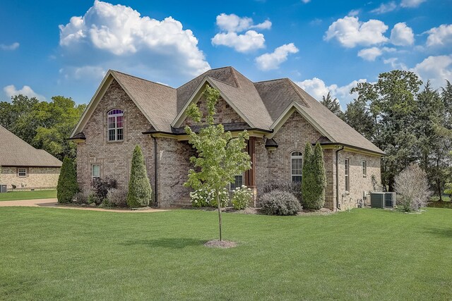 french country inspired facade featuring central AC and a front lawn