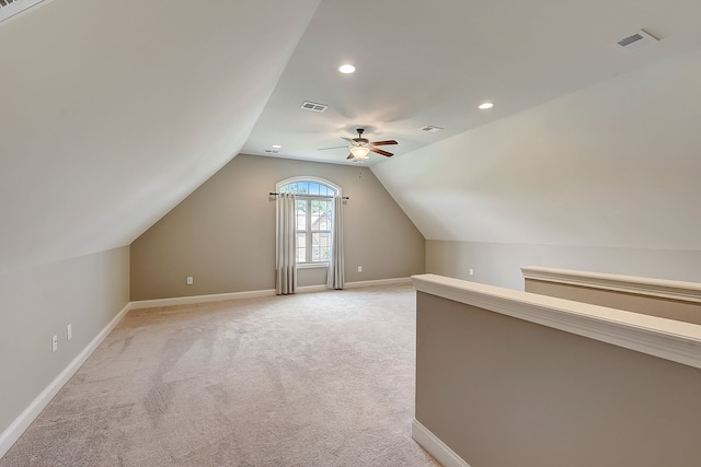 additional living space with light carpet, lofted ceiling, and ceiling fan