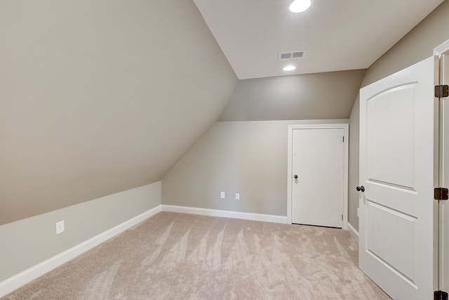 bonus room featuring lofted ceiling and light colored carpet