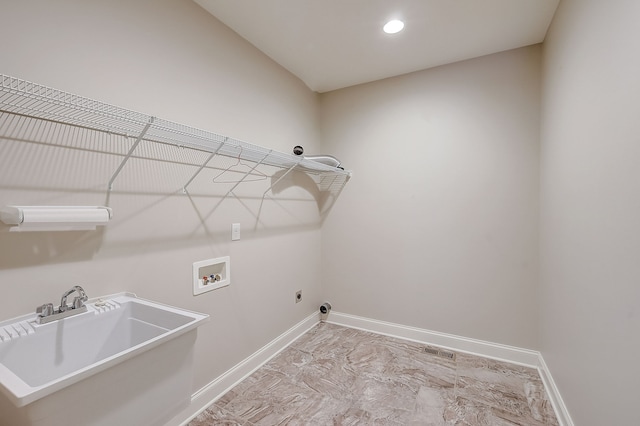 washroom with washer hookup, hookup for an electric dryer, light tile flooring, and sink