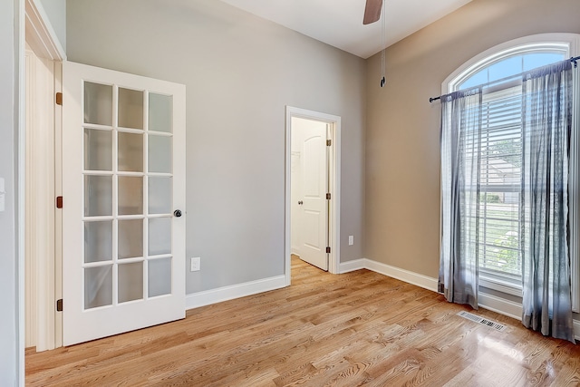 empty room with light hardwood / wood-style flooring and ceiling fan