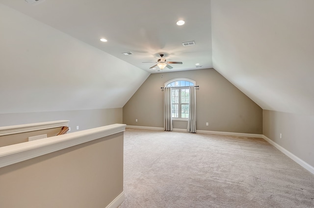 bonus room featuring ceiling fan, lofted ceiling, and light carpet