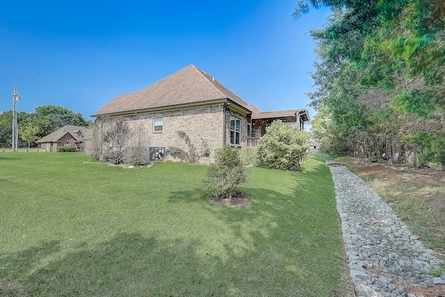 view of side of property with a yard