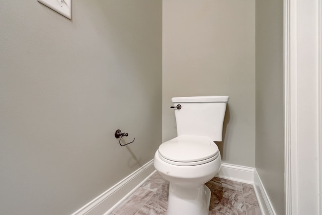 bathroom with toilet and tile floors