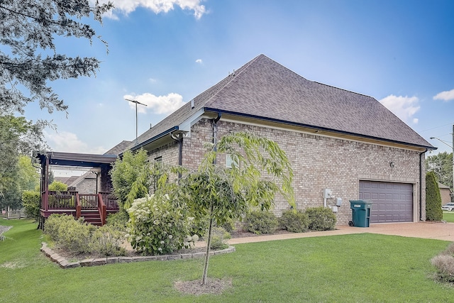 view of side of home featuring a deck, a garage, and a lawn