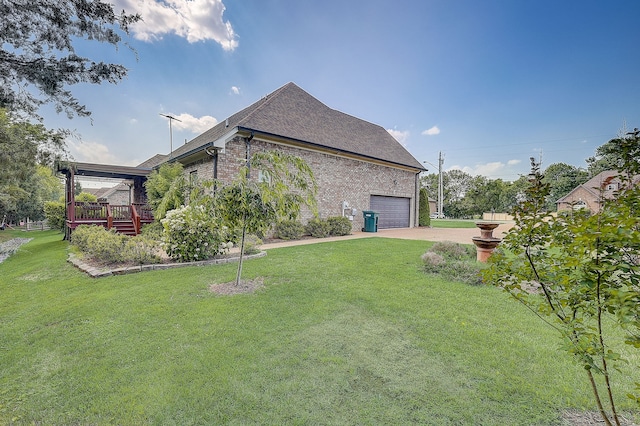 view of property exterior with a deck, a garage, and a lawn