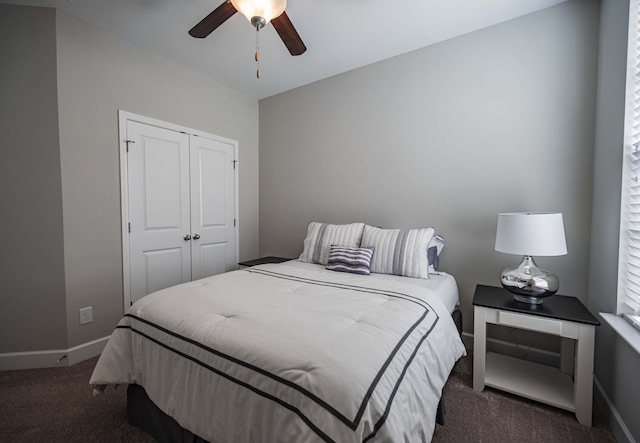 carpeted bedroom with ceiling fan and a closet