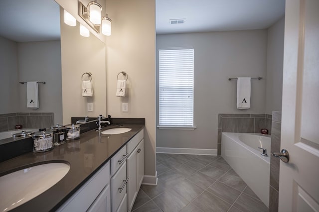 bathroom featuring tile flooring, dual vanity, and a bathtub