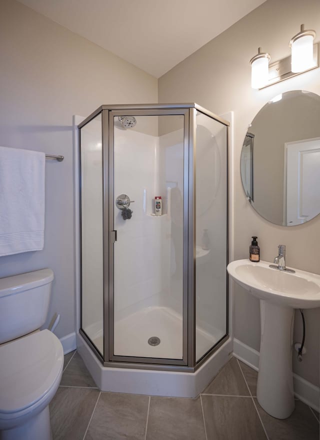 bathroom with an enclosed shower, tile flooring, and toilet