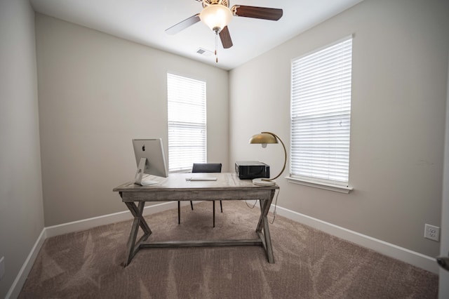 carpeted office featuring ceiling fan