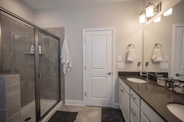 bathroom featuring tile floors, an enclosed shower, and dual bowl vanity