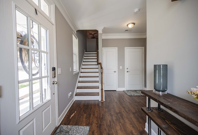 foyer entrance with dark wood-type flooring and crown molding