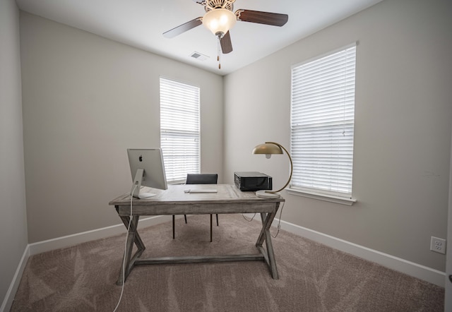 home office with ceiling fan and dark carpet