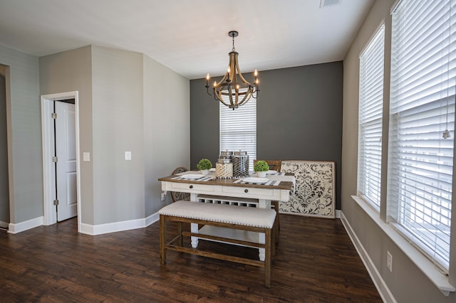 dining room featuring plenty of natural light, a notable chandelier, and dark hardwood / wood-style floors