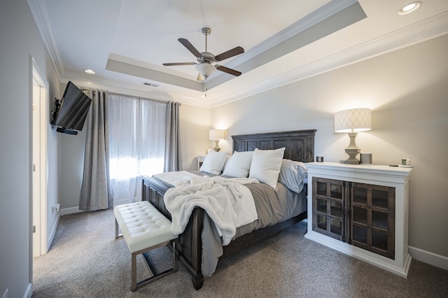 bedroom featuring dark carpet, a raised ceiling, ceiling fan, and crown molding