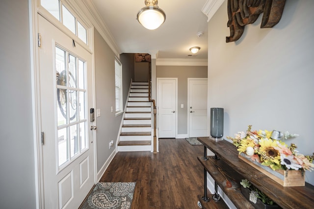 entrance foyer with ornamental molding and dark wood-type flooring