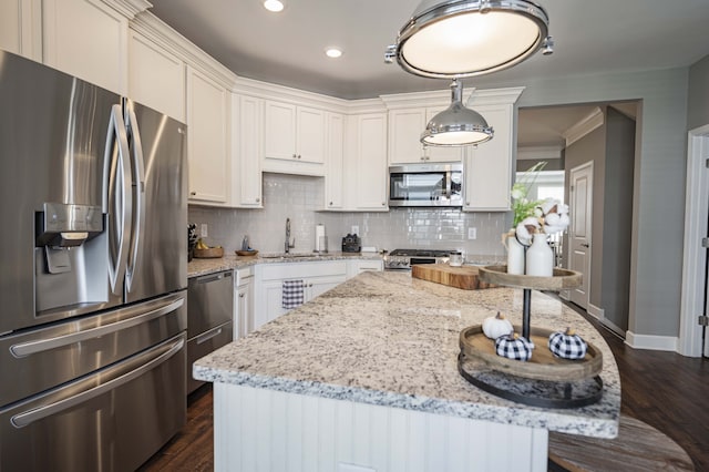 kitchen featuring stainless steel appliances, backsplash, dark hardwood / wood-style flooring, white cabinetry, and light stone countertops