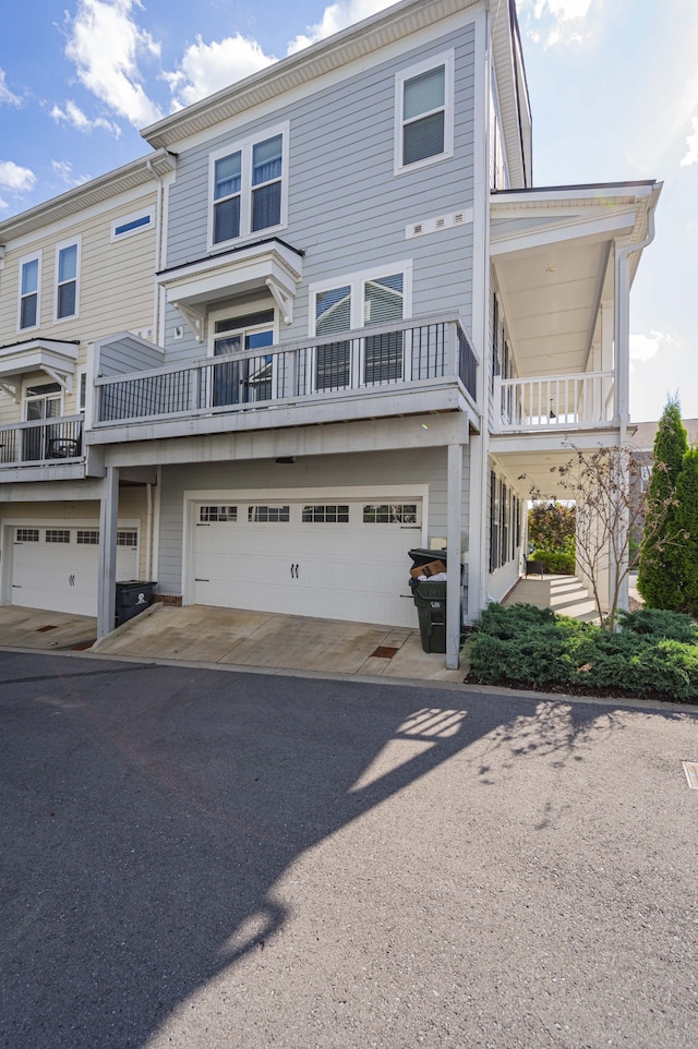 multi unit property with a balcony and a garage