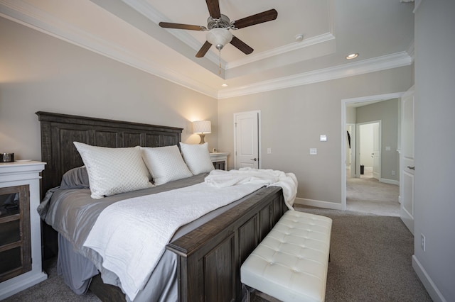 carpeted bedroom featuring ceiling fan, crown molding, and a raised ceiling