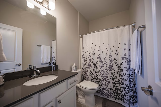 bathroom featuring tile flooring, toilet, and oversized vanity