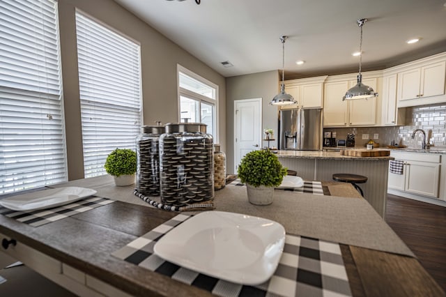 dining area with dark wood-type flooring and sink