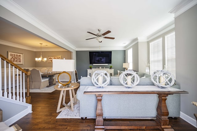 living room with dark hardwood / wood-style floors, ceiling fan with notable chandelier, and ornamental molding