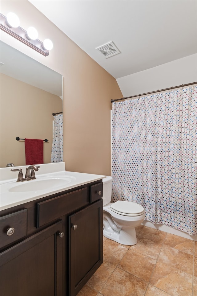 bathroom featuring tile floors, toilet, and vanity